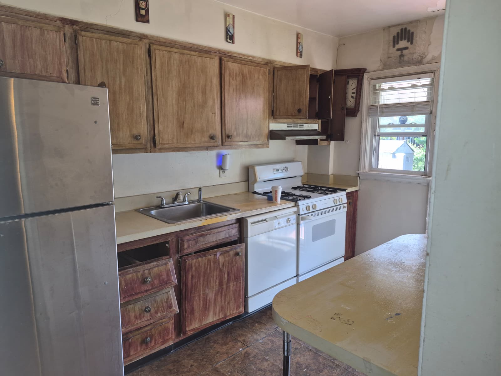 Kitchen before renovation — old cabinets and flooring