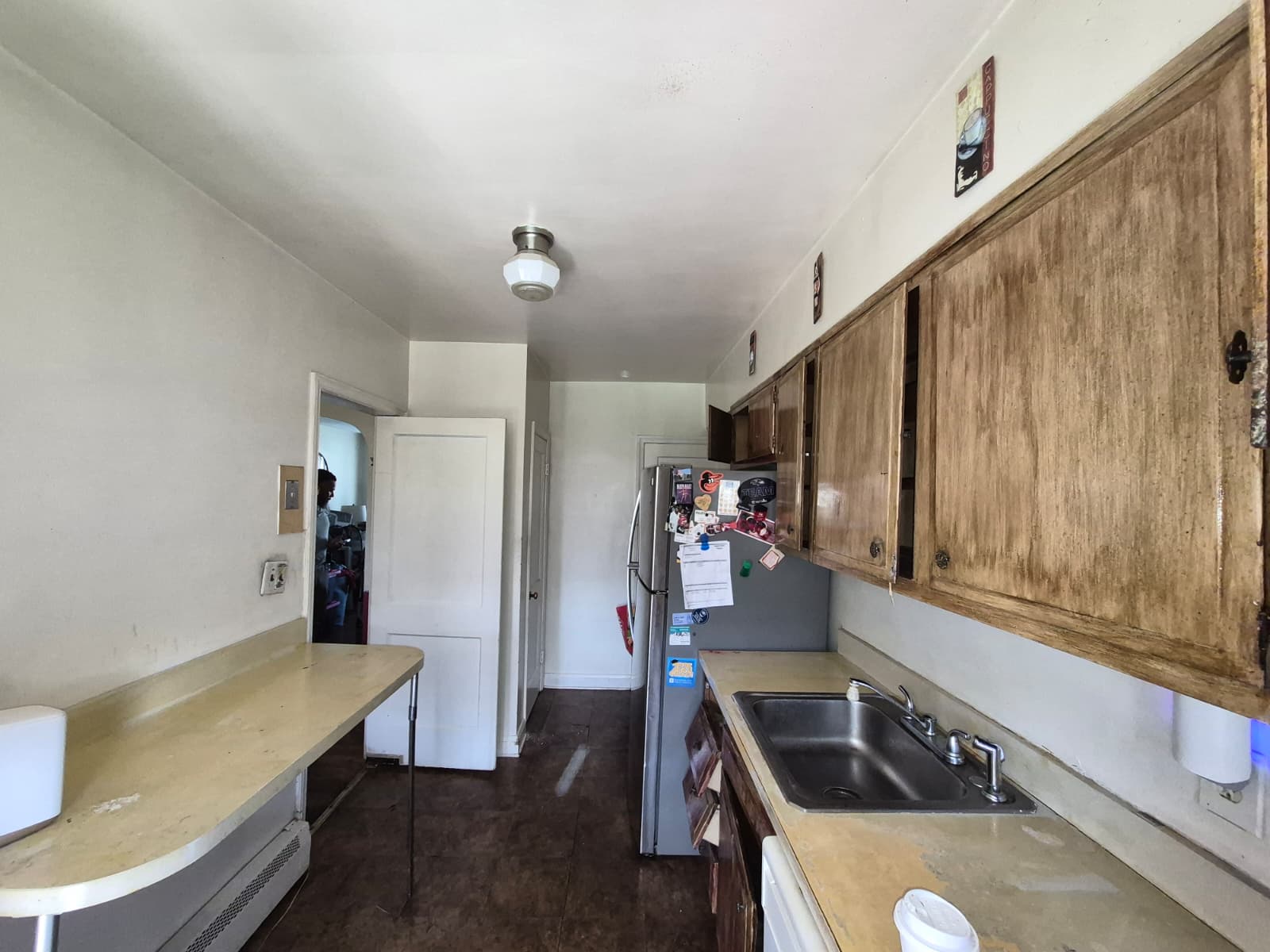 Kitchen before renovation — old cabinets and flooring
