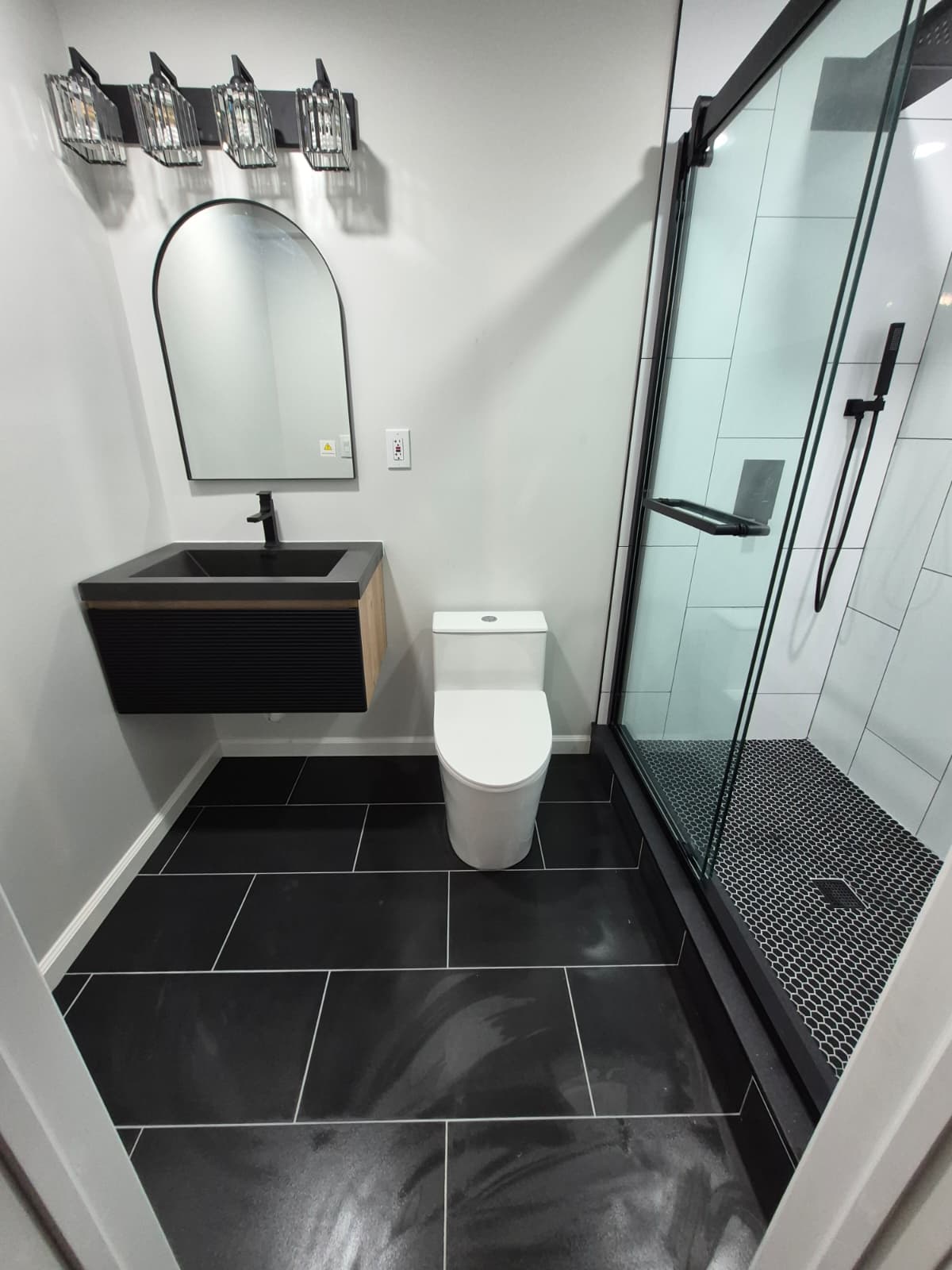 Basement bathroom after renovation — finished tile and fixtures