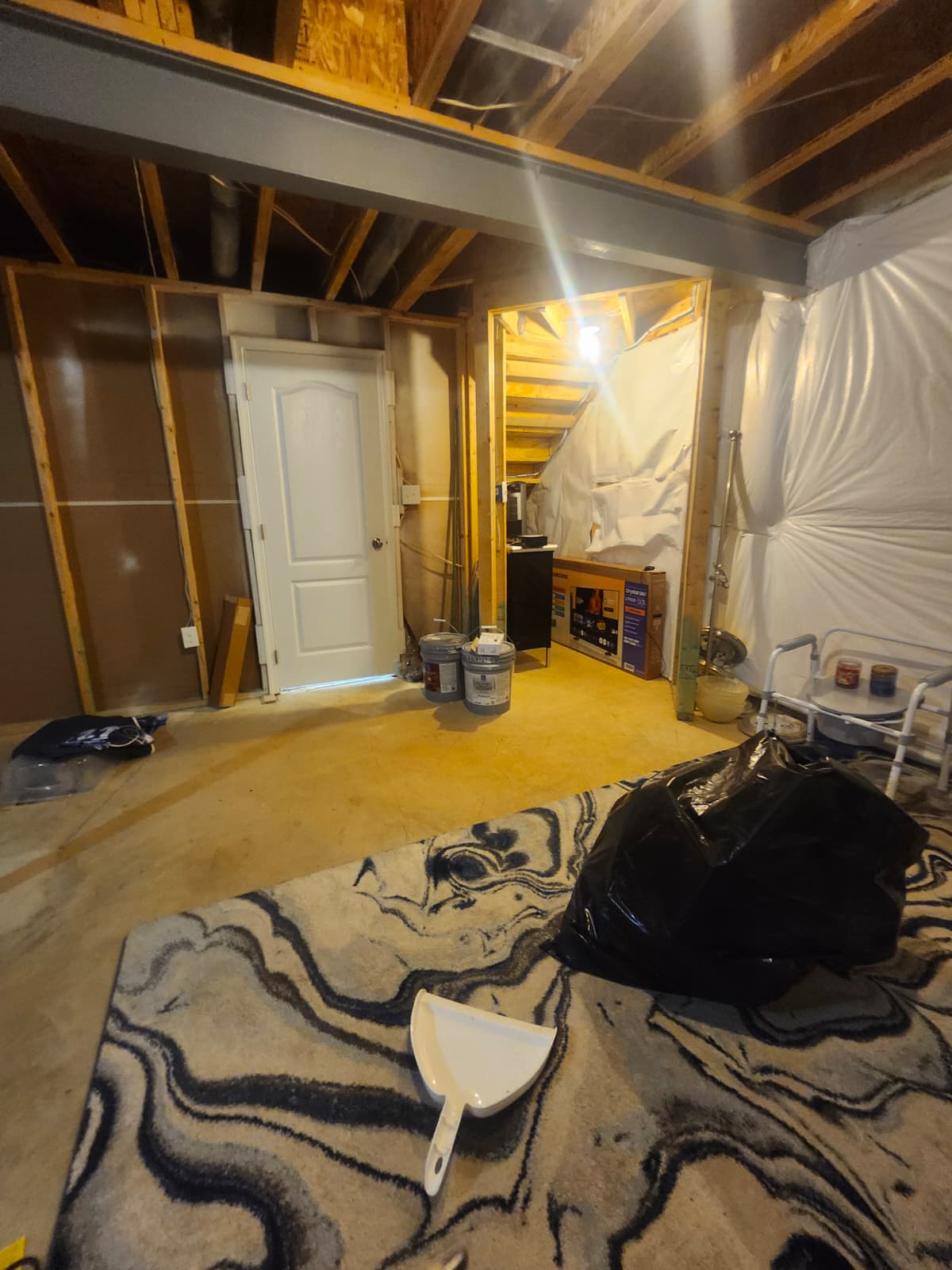 Basement bathroom before renovation — unfinished framing